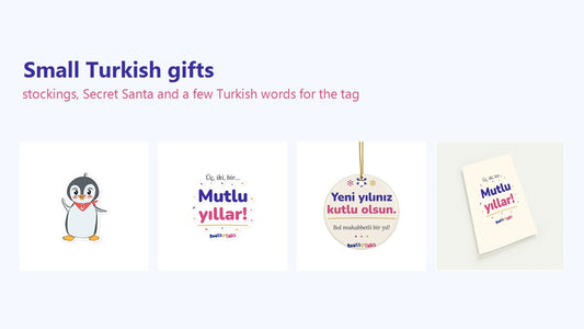 A Pingucan Penguin sticker, a Üç İki Bir Mutlu Yıllar magnet, a Yeni Yılınız Kutlu Olsun ornament and a pack of greeting cards side by side